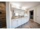 Luxurious bathroom with a large mirror, granite countertop, and modern lighting at 149 Avalon Way, Sharpsburg, GA 30277
