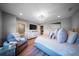 Spacious bedroom with a comfortable chair, ensuite bathroom, and contemporary decor at 149 Avalon Way, Sharpsburg, GA 30277