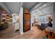 Hallway view showcasing built-in display shelves, a wine cooler, and an elegant seating area at 149 Avalon Way, Sharpsburg, GA 30277