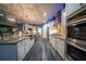 Spacious kitchen boasts stainless appliances, granite countertops, and modern lighting fixtures at 149 Avalon Way, Sharpsburg, GA 30277