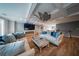 Inviting living room featuring a fireplace, stylish ceiling fan, and comfortable seating at 149 Avalon Way, Sharpsburg, GA 30277