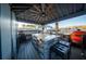 Outdoor kitchen with grill, stone island, stainless appliances, and comfortable seating at 149 Avalon Way, Sharpsburg, GA 30277