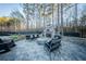 Outdoor patio with a stone fireplace, seating area, and stone pavers at 149 Avalon Way, Sharpsburg, GA 30277