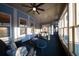Inviting sunroom featuring comfortable lounge seating and natural light from surrounding windows at 149 Avalon Way, Sharpsburg, GA 30277