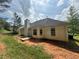The backyard features a charming patio area, perfect for outdoor entertaining and enjoying the peaceful surroundings at 160 Goldleaf Dr, Hampton, GA 30228
