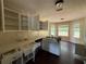 Bright kitchen with white cabinets, double sink, and abundant natural light from multiple windows at 160 Goldleaf Dr, Hampton, GA 30228