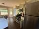 Well-equipped kitchen with stainless steel appliances and ample counter space adjacent to dining area at 160 Goldleaf Dr, Hampton, GA 30228