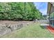 Picturesque backyard featuring a well-maintained lawn, rock border, and exterior view of home at 2842 Sedgeview Ln, Buford, GA 30519