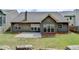 Backyard featuring a well-maintained lawn, concrete patio, and inviting home exterior at 2842 Sedgeview Ln, Buford, GA 30519