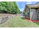 Lush backyard with rock wall, green lawn, and a concrete patio, perfect for outdoor enjoyment at 2842 Sedgeview Ln, Buford, GA 30519