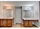 Bathroom featuring double vanities with wooden cabinets and a door separating the shower area at 2842 Sedgeview Ln, Buford, GA 30519