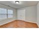Bedroom with hardwood floors, neutral walls, a window and double closet doors at 2842 Sedgeview Ln, Buford, GA 30519