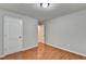 Bright bedroom featuring wood-look floors, neutral paint, and two white doors at 2842 Sedgeview Ln, Buford, GA 30519