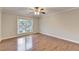 A bright bedroom featuring a ceiling fan and luxury vinyl plank flooring throughout at 2842 Sedgeview Ln, Buford, GA 30519