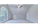 Large bonus room with vaulted ceiling, big window, fan, and neutral paint at 2842 Sedgeview Ln, Buford, GA 30519