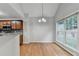 Bright dining area with hardwood floors, large windows, and modern lighting fixture at 2842 Sedgeview Ln, Buford, GA 30519