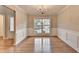 Elegant dining area bathed in natural light with hardwood flooring and tasteful wainscoting at 2842 Sedgeview Ln, Buford, GA 30519