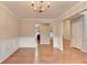 Open-concept dining room with hardwood floors and decorative wainscoting with lots of space at 2842 Sedgeview Ln, Buford, GA 30519