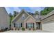 Attractive exterior showcasing a brick accent, complemented by a manicured lawn and a two-car garage at 2842 Sedgeview Ln, Buford, GA 30519