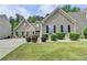 Well-manicured front lawn and carefully placed landscaping enhances the charm of this two-story home at 2842 Sedgeview Ln, Buford, GA 30519