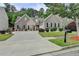 Charming home with a large driveway, well manicured lawn, brick accents and manicured landscaping at 2842 Sedgeview Ln, Buford, GA 30519