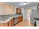 Spacious kitchen with stainless steel appliances, breakfast bar, and view into the dining room at 2842 Sedgeview Ln, Buford, GA 30519