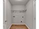 Efficient laundry room with wood-look tile flooring and neutral walls ready for appliance hookups at 2842 Sedgeview Ln, Buford, GA 30519
