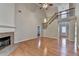 Open-concept living room with high ceilings, fireplace, and staircase leading to the second floor at 2842 Sedgeview Ln, Buford, GA 30519