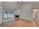 Bright living room with hardwood floors, fireplace, and large windows showcasing the outdoor view at 2842 Sedgeview Ln, Buford, GA 30519