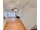 Open-concept living room with hardwood floors, fireplace, fan, and large windows at 2842 Sedgeview Ln, Buford, GA 30519