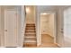 Traditional staircase with neutral carpet treads leads to the second floor, next to a closet at 2842 Sedgeview Ln, Buford, GA 30519