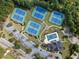 Overhead view of tennis courts, a pool, clubhouse, parking, and manicured green spaces in the community at 3865 Brookhollow Dr, Douglasville, GA 30135