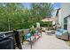 Back deck features ample seating, rug, and a view of wooded backyard at 3865 Brookhollow Dr, Douglasville, GA 30135