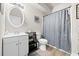 Bathroom features a vanity with a white sink, toilet, and shower with gray curtain at 3865 Brookhollow Dr, Douglasville, GA 30135