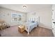 Cozy bedroom with a blue bedding, white furniture, and a window that looks out onto the neighborhood at 3865 Brookhollow Dr, Douglasville, GA 30135