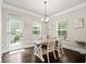 Cozy dining room with a farmhouse table, access to the back porch, and natural lighting at 3865 Brookhollow Dr, Douglasville, GA 30135