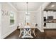 Bright dining room with dark wood floors, a farmhouse table and chairs, and views to the kitchen at 3865 Brookhollow Dr, Douglasville, GA 30135