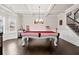 Inviting game room featuring a pool table, custom lighting, dark wood floors and coffered ceilings at 3865 Brookhollow Dr, Douglasville, GA 30135