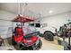 Spacious garage featuring a golf cart, car, and ample storage space at 3865 Brookhollow Dr, Douglasville, GA 30135