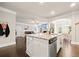 Kitchen island boasts granite counters, a stainless dishwasher, and a view to the living and dining spaces at 3865 Brookhollow Dr, Douglasville, GA 30135