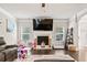 Living room view shows a fireplace with TV, windows, and neutral decor at 3865 Brookhollow Dr, Douglasville, GA 30135