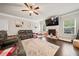 Spacious living room with a ceiling fan, a fireplace with a TV, and comfortable seating at 3865 Brookhollow Dr, Douglasville, GA 30135