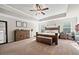 Large main bedroom with a tray ceiling, dark wood furniture, and lots of natural light at 3865 Brookhollow Dr, Douglasville, GA 30135