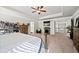 Spacious main bedroom featuring a tray ceiling, ceiling fan, fireplace and access to the upper hall at 3865 Brookhollow Dr, Douglasville, GA 30135
