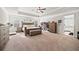 Spacious main bedroom with a large bed, tray ceiling, and natural light at 3865 Brookhollow Dr, Douglasville, GA 30135
