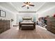 Expansive main bedroom with a large bed and walk-in closet shoe organizer at 3865 Brookhollow Dr, Douglasville, GA 30135