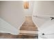View of the carpeted staircase with white walls and handrail, leading to the upper level of the home at 3865 Brookhollow Dr, Douglasville, GA 30135