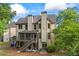 Two-story house with a deck, screened-in porch, patio, stairs, and a lush backyard at 414 Silver Top Dr, Grayson, GA 30017