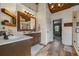 Elegant bathroom with wood-look tile, double sink vanity, stylish lighting, and a glass-enclosed shower at 414 Silver Top Dr, Grayson, GA 30017