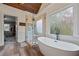 This bathroom boasts a free standing tub, glass shower, and neutral tones creating a spa-like retreat at 414 Silver Top Dr, Grayson, GA 30017